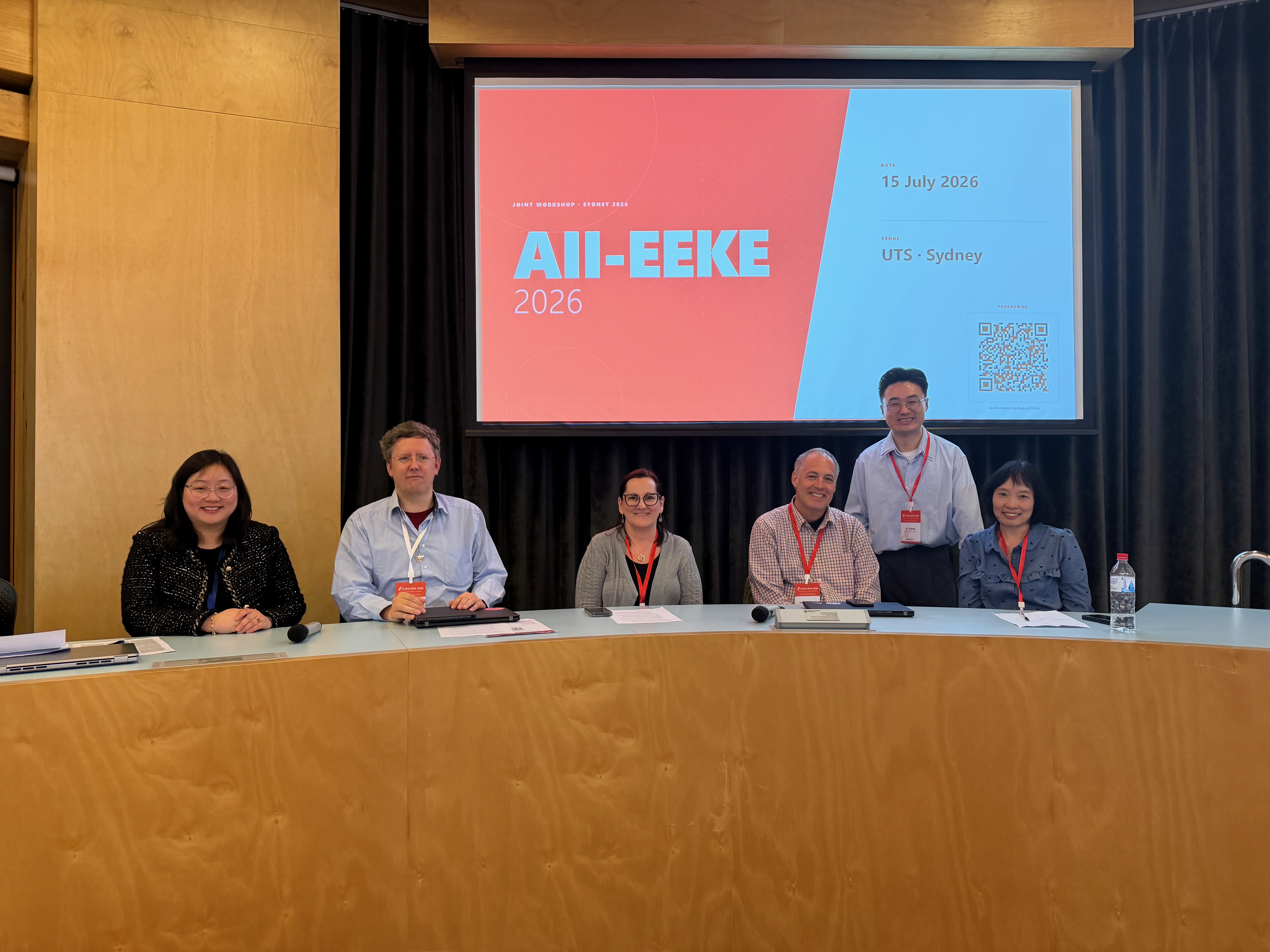 AII-EEKE 2026 panel session with chairs at the front desk